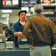 Cashier Duane Hesketh and customer Robert Lalley eye each other with disgust.